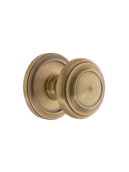 Grandeur Circulaire Rosette Door Set with Circulaire Knobs in Antique Brass.